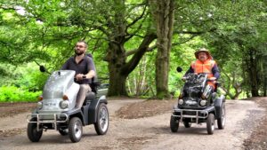 Two tramper users enjoying woodland at Sutton Park. One driver wears a high viz jacket and hat