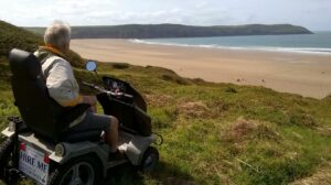 Man in tramper looking out to the beach at Woolacombe