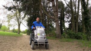 ﻿Man explores Robinswood Hill Country Park Woodland on tramper, driving along a tree lined path