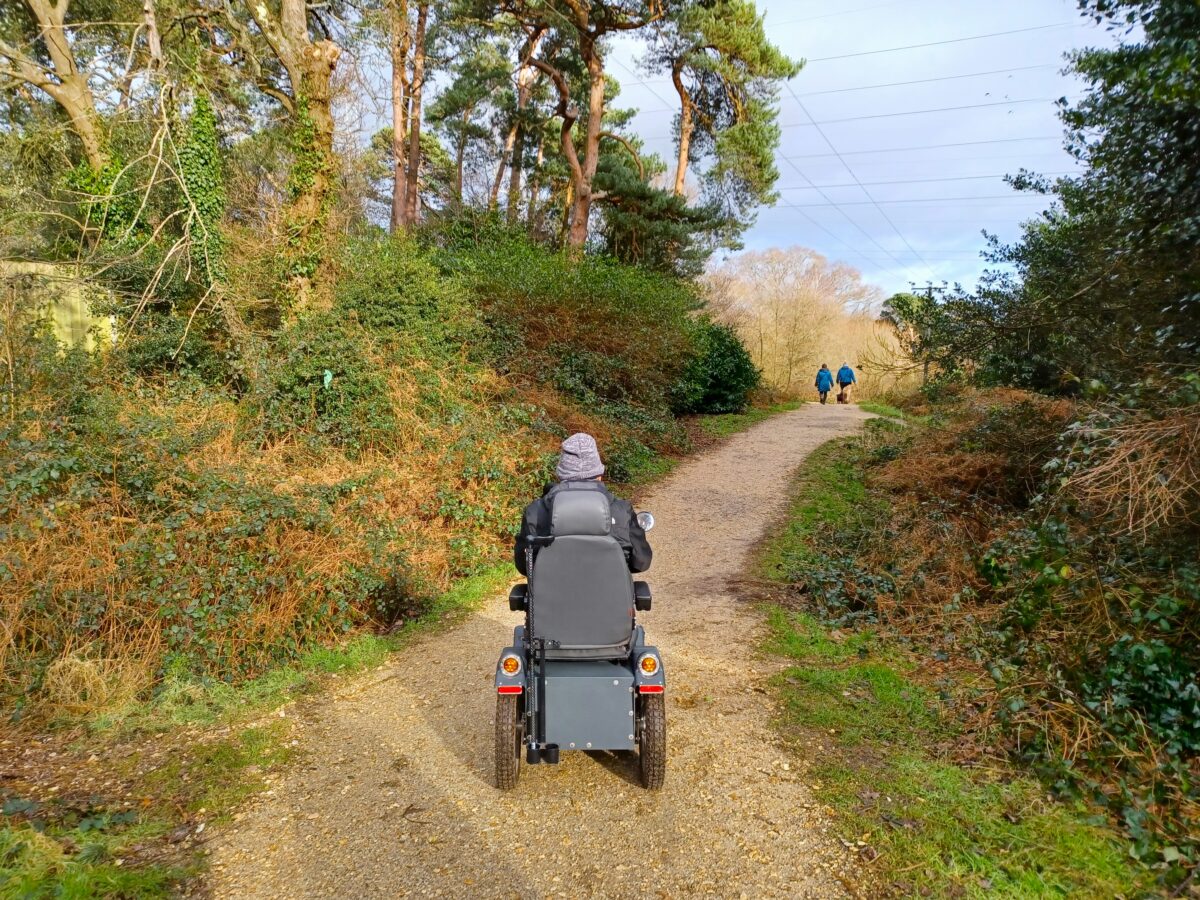 All terrain mobility scooter passing through a clearing in Upton Country Park