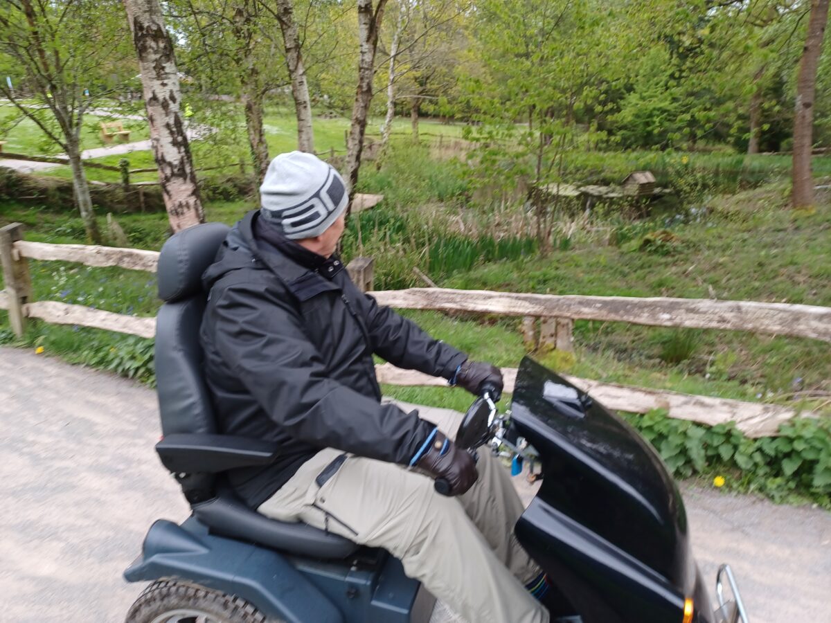 Visitor on an all terrain mobility scooter