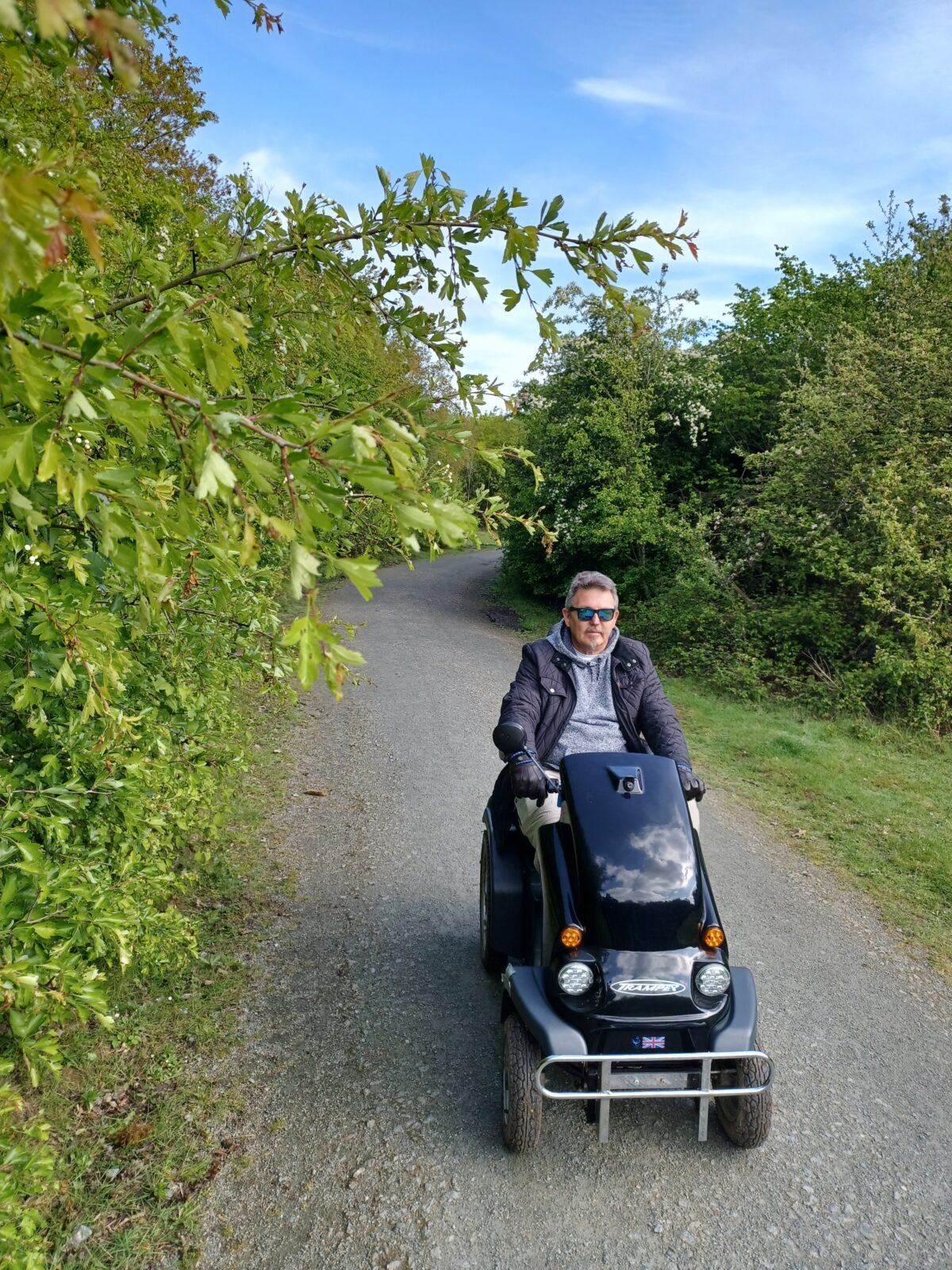 Man on a Tramper all terrain mobility scooter explores the woodlands at Thames Chase