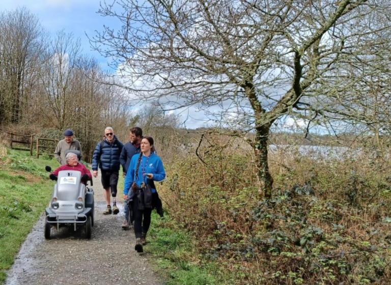 A group walk alongside a Tramper lakeside