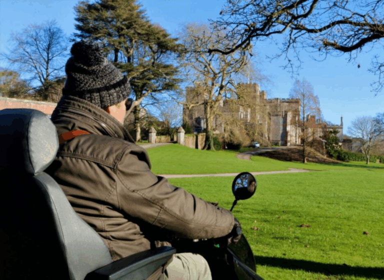 A man in winter clothes is on a Tramper. In the distance is a castle.
