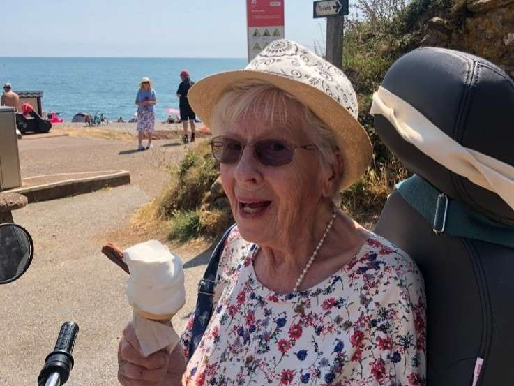 Eve smiling and eating an ice cream on her Tramper